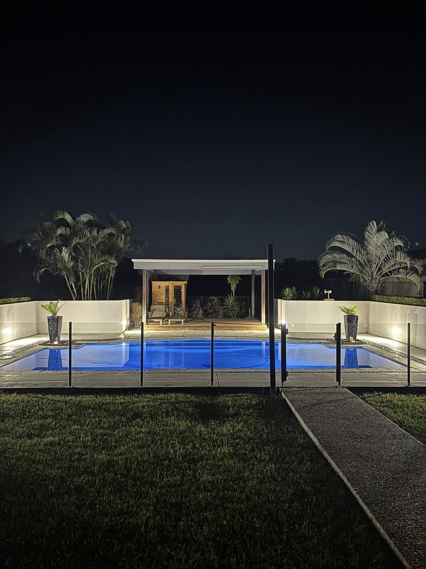 Pool LED lighting installation at night - underwater and landscape lighting by Fully Spark'd Electrical Cedar Grove